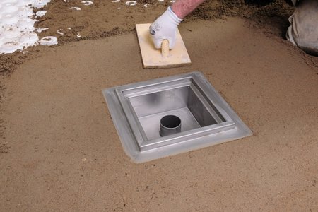 The screed is applied to create a sufficient gradient to the floor drain.