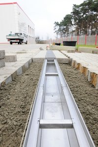 The adjacent paving stones were able to be directly embedded into the concrete next to the channel.