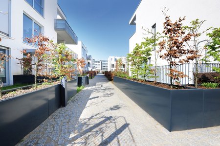 Passages and walkways leading between the two and three-storey residential buildings connect the different areas of the complex.