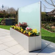 Metall Pflanzkasten aus Edelstahl mit satiniertem Glas als Rückwand auf der Terrasse im Garten