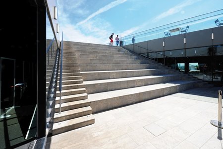 Aan de zijkanten van de trappen zorgen drainagegoten van het type Stabile voor een betrouwbare afwatering.  Dankzij hun positionering naast de trapleuning gaan de goten decent op in de buitenruimte.