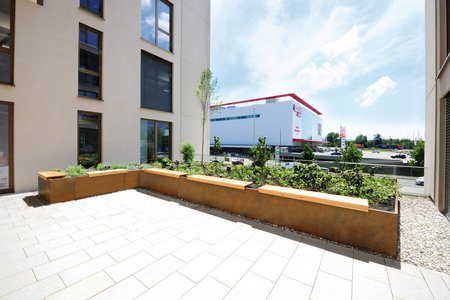 Seating was added to one of the raised bed structures so as to make the space as enjoyable as possible for the building’s users. The front of each seat is aligned with the top of the raised bed structure.