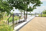 Die 80 mm hohen Rinnen der Richard Brink GmbH & Co. KG aus Beton unterstreichen in Kombination mit den Gussrosten „Zippa“ auch das Farbkonzept, geprägt durch dunkle Geländer und Streifen entlang der Treppen.  Foto: Richard Brink GmbH & Co. KG