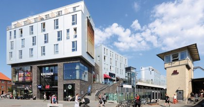 A unique building complex has emerged in the Vanløse district of Copenhagen, combining modern living with a myriad of shopping options. 