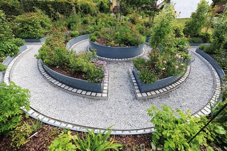 A total of five radial raised beds come together to form a circular, accessible maze and flourishing oasis that the property’s residents can enjoy for years to come.