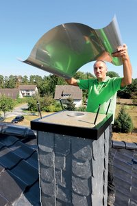 The wavy chimney cap is placed on top of the shuttering frame supports.