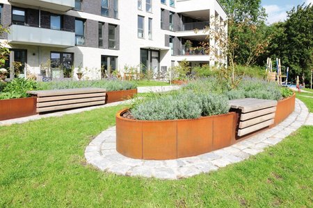 Thanks to their integrated, wooden seating areas, the 450mm-high planting systems invite passers-by to sit and take in the courtyard.